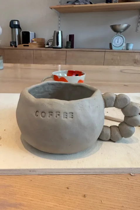 Creating a mug in my pottery class
